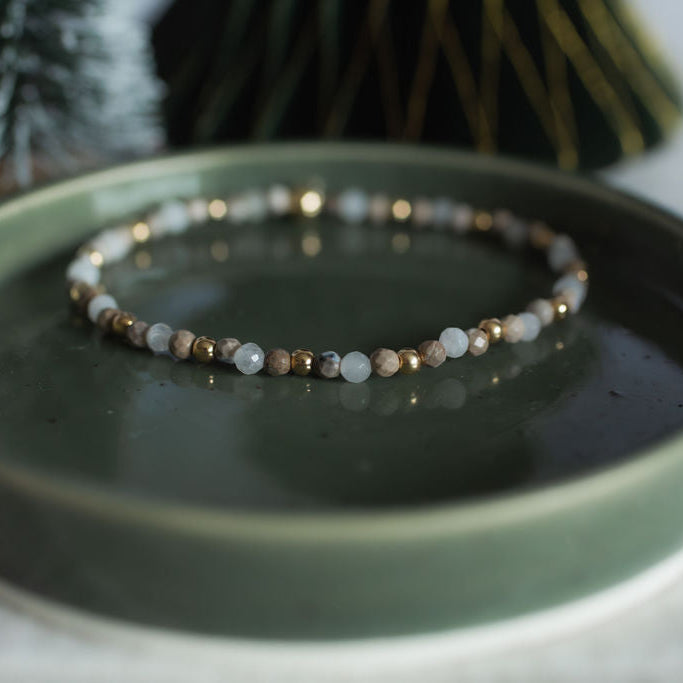 Bracelet on a green ceramic dish with a blurred background